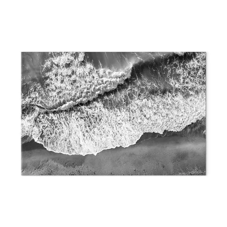Ocean shore - black and white photograph of waves hitting the beach