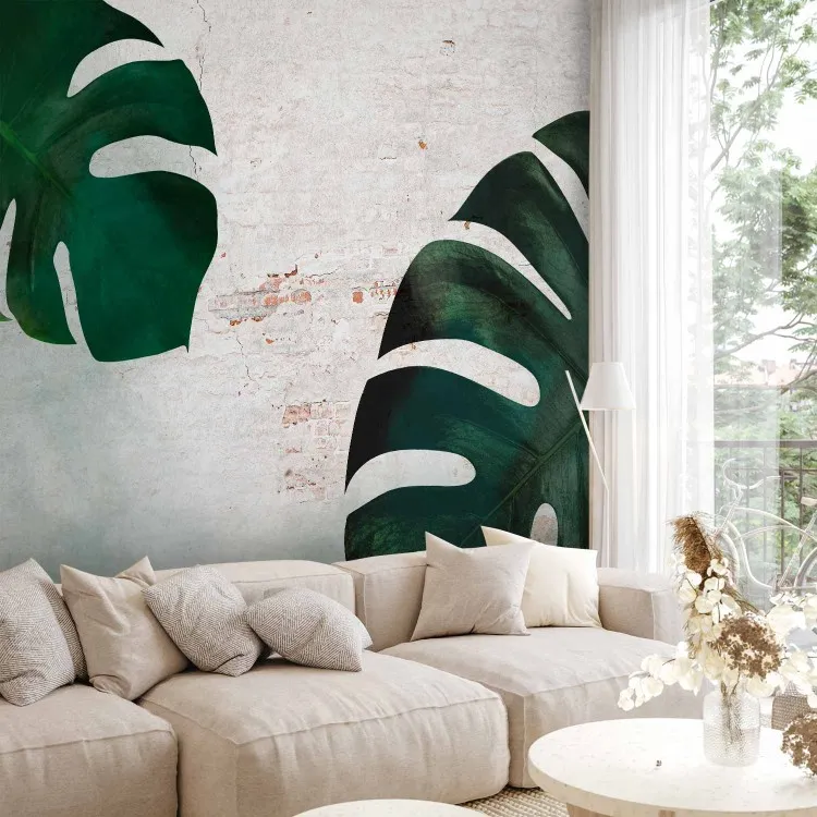 Exotic leaves - composition with monstera on a brick wall background