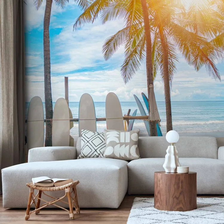 Boards on the beach - surfing equipment in the shade of tropical trees